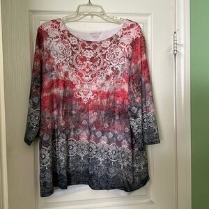 Tunic predominantly red and blue with a white Lacey pattern on top